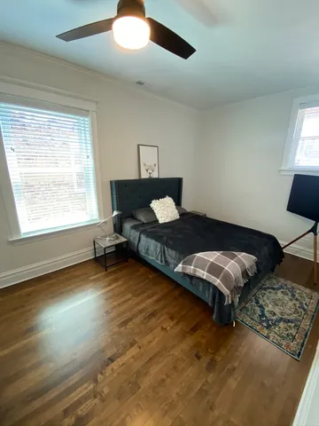 a living room with hard wood floors furniture and a window