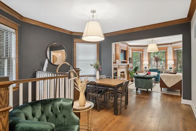 a living room with furniture a fireplace and a chandelier