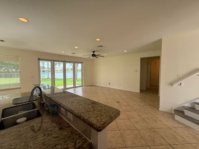 a room with pool table and windows