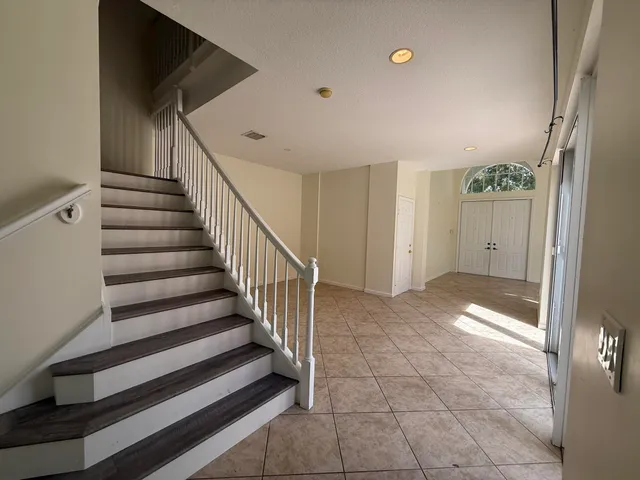 a view of entryway with stairs and wooden floor