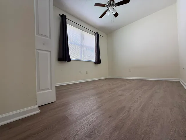 wooden floor in an empty room with a window