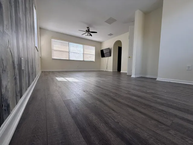 wooden floor in an empty room with a window