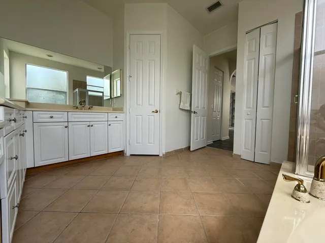 a view of a bathroom with mirror and bathtub