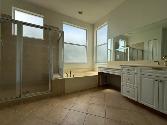 a bathroom with a granite countertop sink a toilet and bathtub