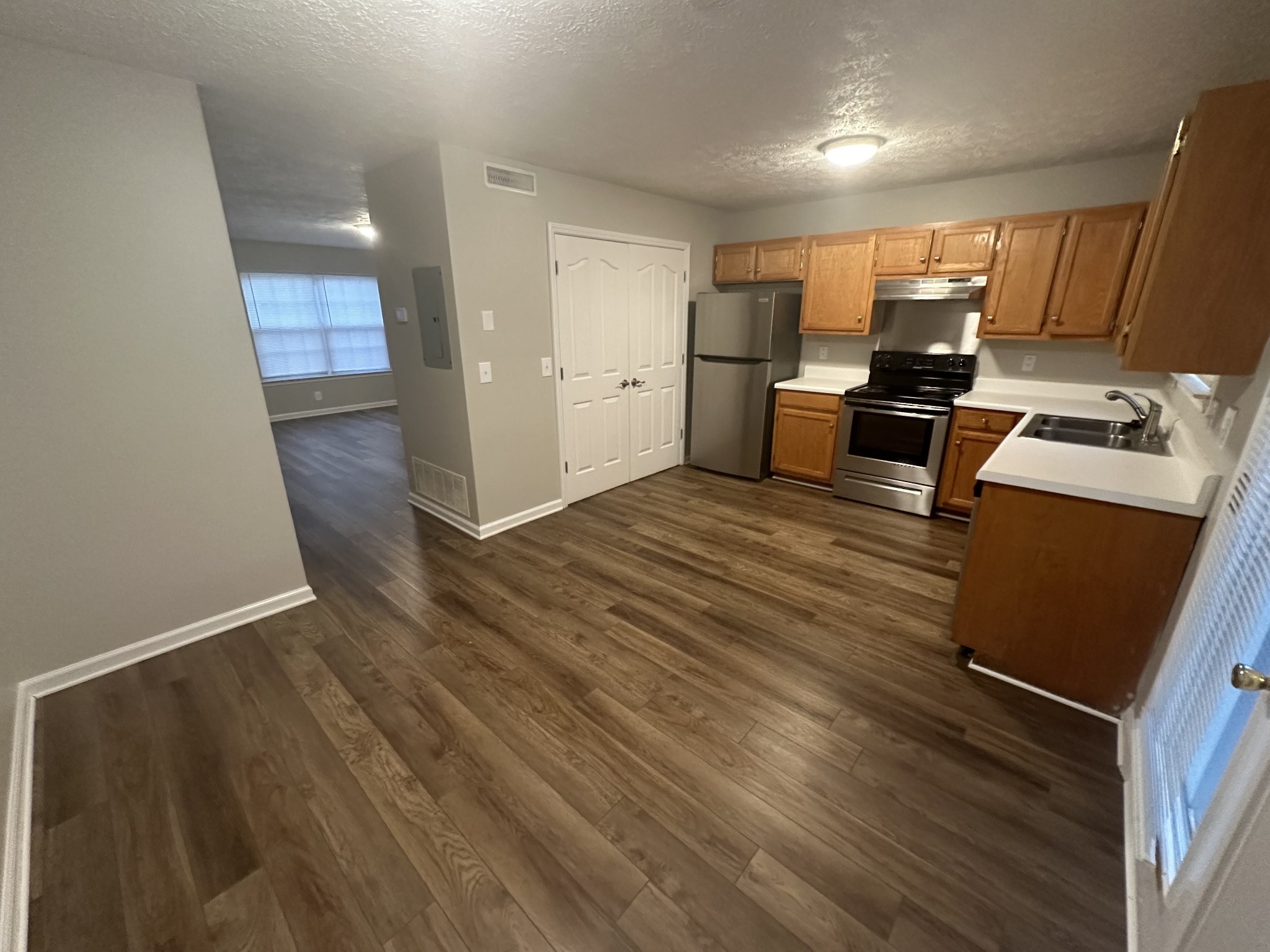 2410 Willowbrook Drive, Unit B Murfreesboro, TN 37130 - Photo 7 of 14 a kitchen with stainless steel appliances wooden floor and a refrigerator