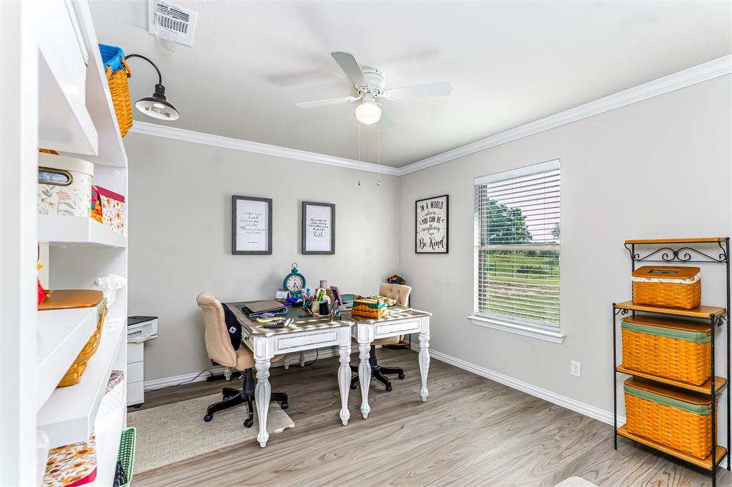 129 Springwood Ranch Loop Springtown, TX 76082 - Photo 22 of 29 Wood-finish flooring, crown molding, and a ceiling fan
