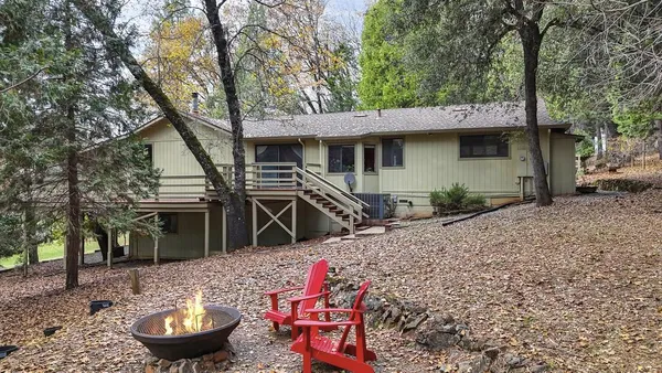 a backyard of a house with barbeque oven table and chairs