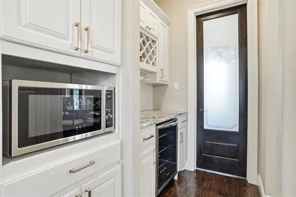 a kitchen with a refrigerator and a stove
