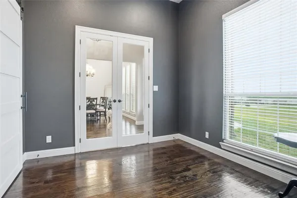 a view of wooden floor and windows in a room