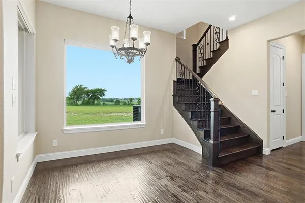 a view of entryway with stairs and wooden floor