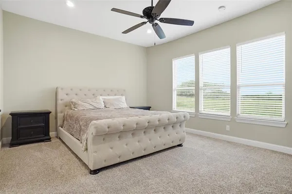 a bedroom with a bed dresser and a window