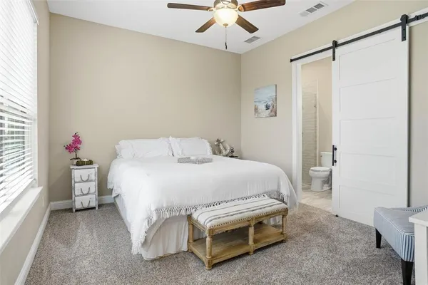 a bed room with a bed and a chandelier