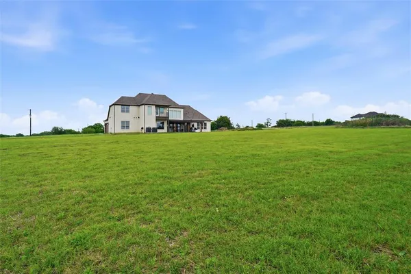 a view of a big yard with a house