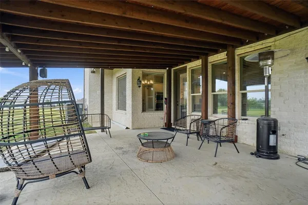 a building outdoor space with patio furniture and potted plants