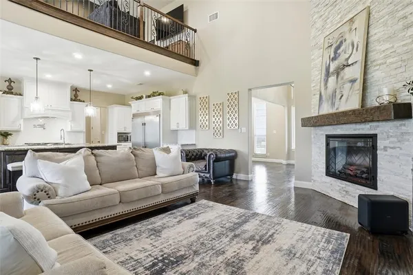 a living room with furniture wooden floor and a fireplace