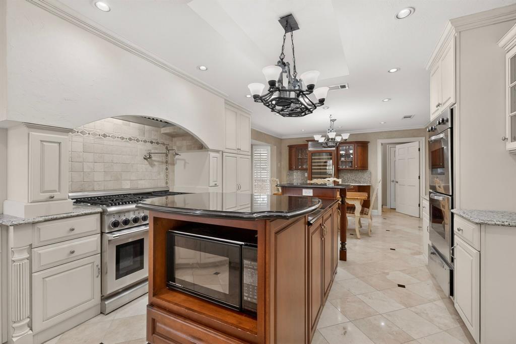 2405 Wing Point Lane Plano, TX 75093 - Photo 16 of 39 a kitchen with stainless steel appliances granite countertop a stove and a sink