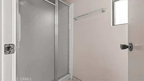 a bedroom with a bed and painting on the wall