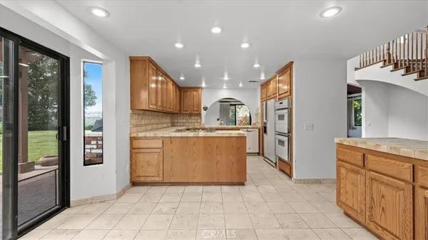 a kitchen with cabinets and a stove top oven