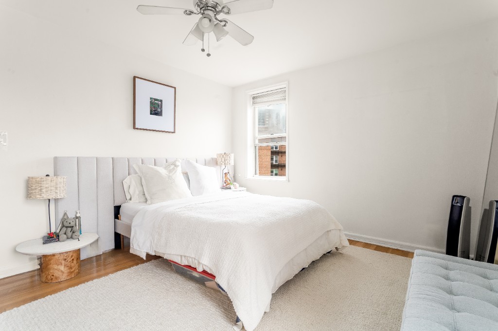 5614 Netherland Avenue, Unit 5C Bronx, NY 10471 - Photo 2 of 9 a bedroom with bed and a chandelier