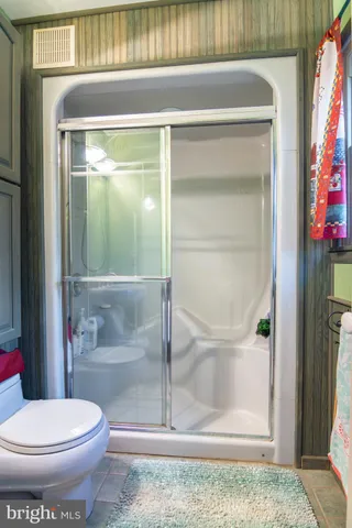 a bathroom with a toilet and a shower