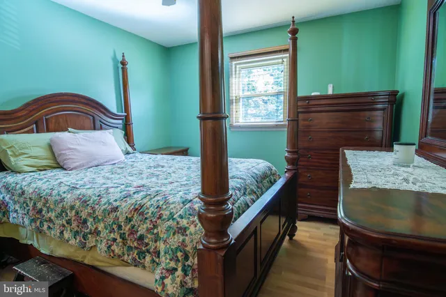a bedroom with a bed and a dresser