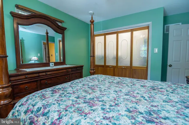 a bedroom with a bed and a large dresser