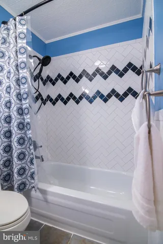 a bathroom with a bathtub and shower