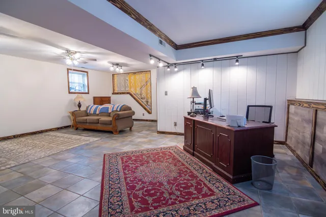 a living room with furniture and a mirror