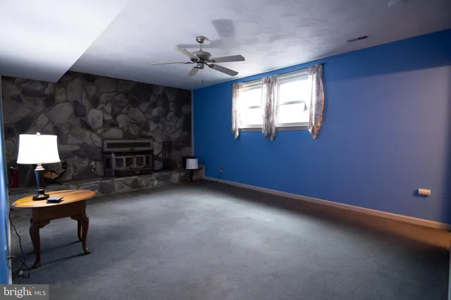 a view of a livingroom with furniture and a fireplace