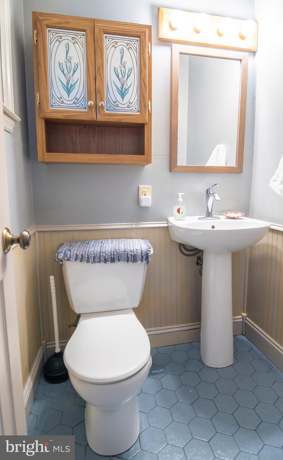 163 Rock Hill Church Road Stafford, VA 22556 - Photo 32 of 43 a bathroom with a toilet a sink and mirror