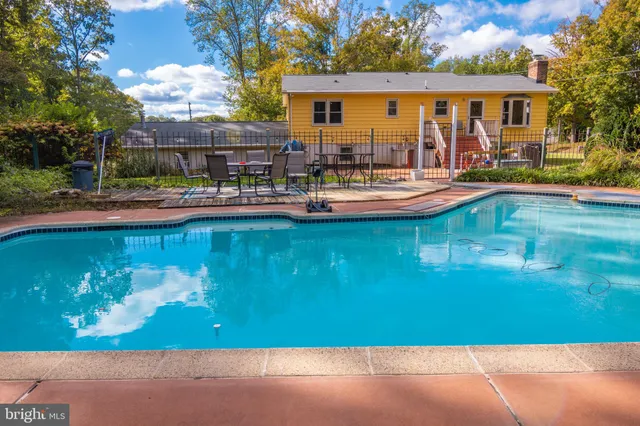 a front view of house with swimming pool yard and outdoor seating