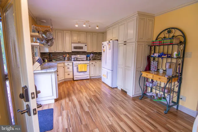 a view of kitchen with furniture and wooden floor