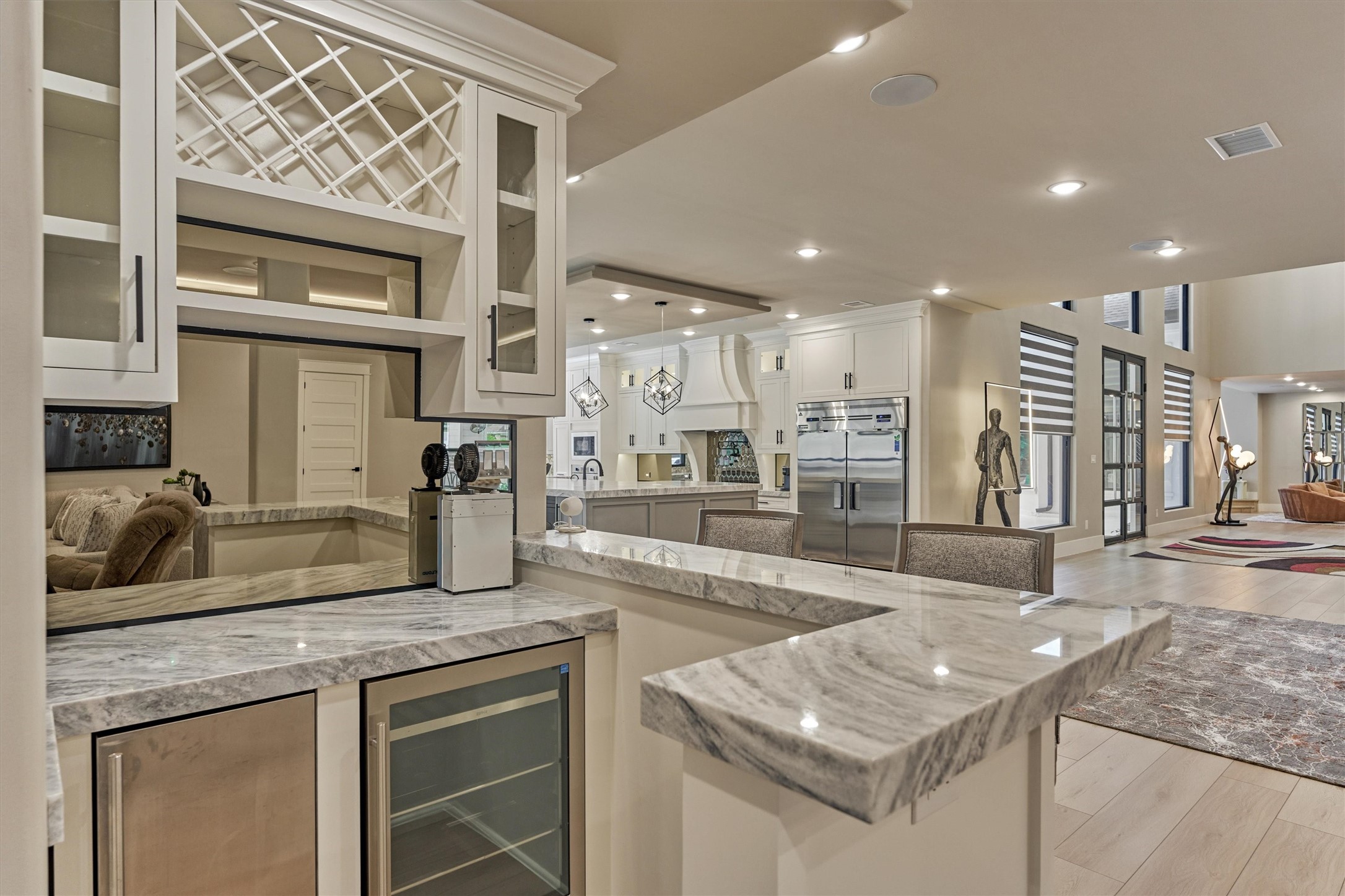1907 Woerner Road Houston, TX 77090 - Photo 12 of 50 Conveniently located off of the family room, this chic wet bar features a new wine fridge, ice machine, wine storage and gorgeous Quartzite countertops.