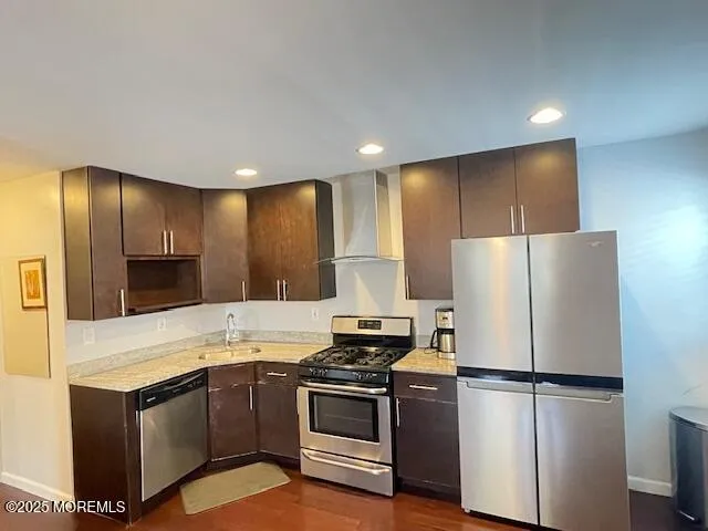 a kitchen with stainless steel appliances a refrigerator sink and microwave