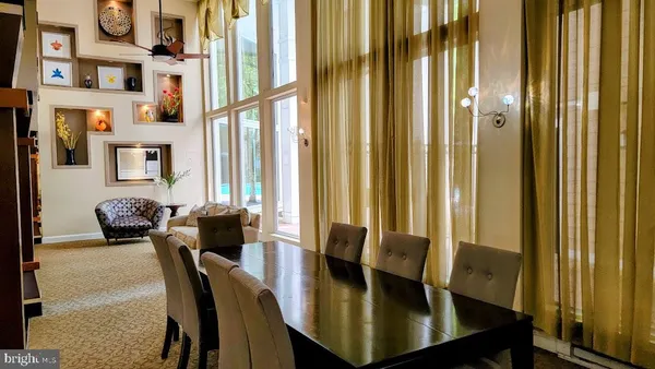 a living room with a black white checkered floor with couches chair and a coffee table