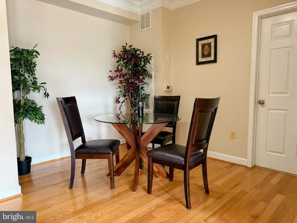 a view of a dining room with furniture and wooden floor