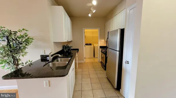a kitchen with a sink and refrigerator