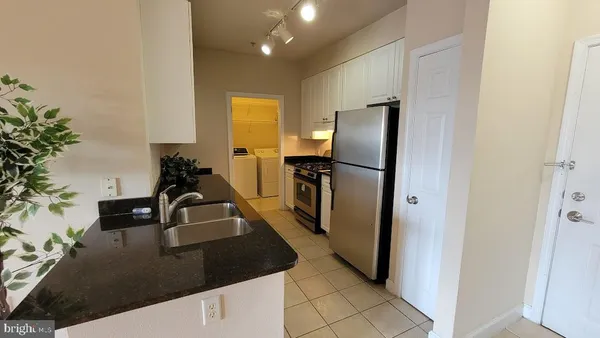 a kitchen with refrigerator and sink
