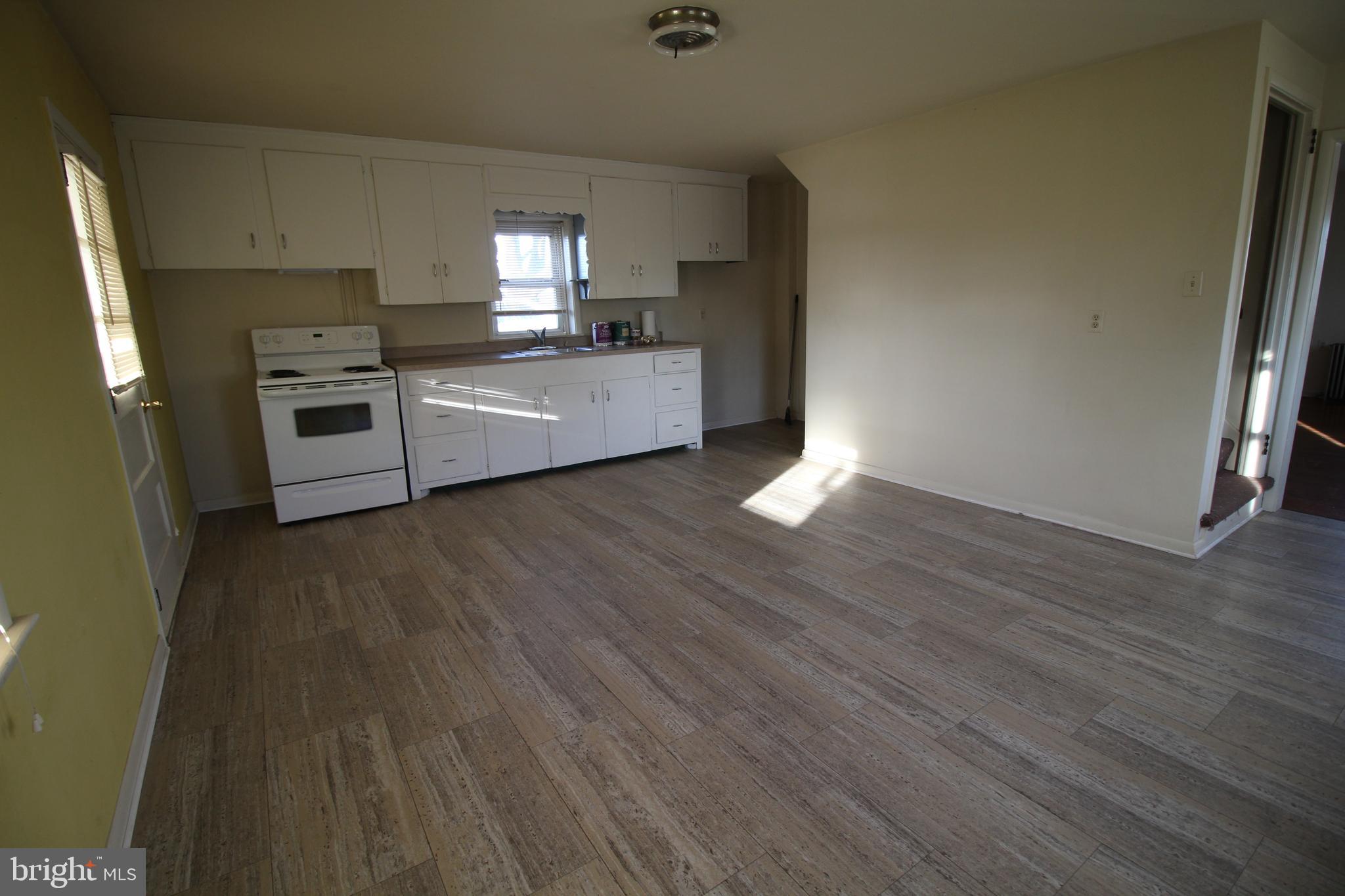 1074 Georgetown Road Paradise, PA 17562 - Photo 2 of 7 a kitchen with cabinets wooden floor and stainless steel appliances
