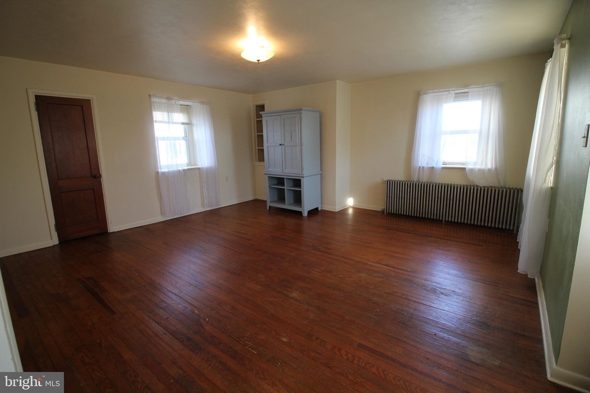1074 Georgetown Road Paradise, PA 17562 - Photo 3 of 7 a view of an empty room with wooden floor and a window