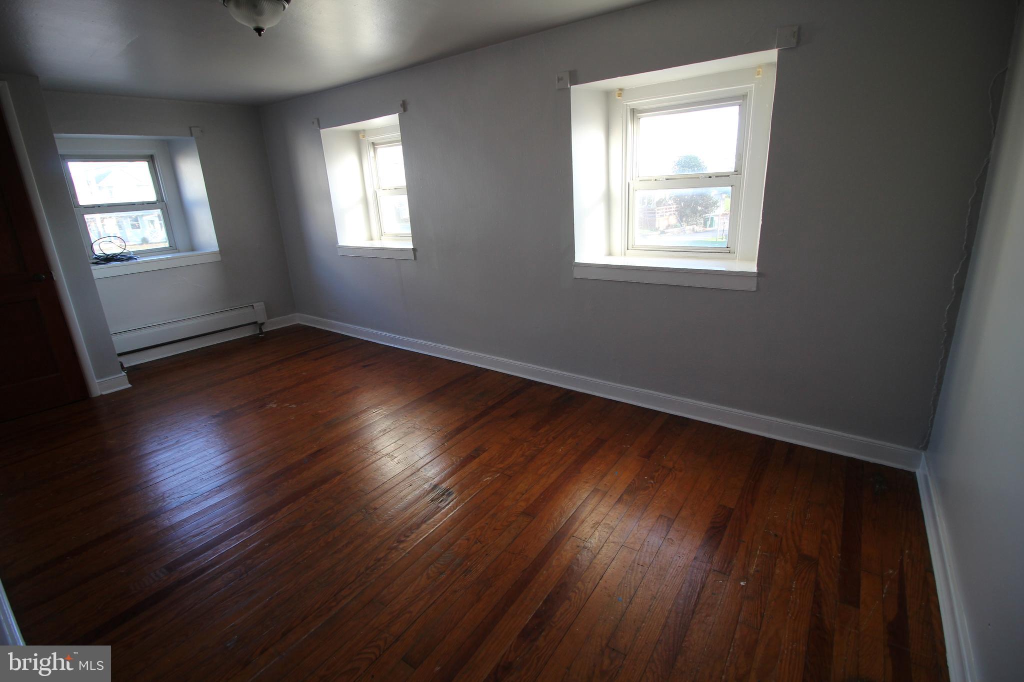 1074 Georgetown Road Paradise, PA 17562 - Photo 5 of 7 a view of an empty room with wooden floor and a window
