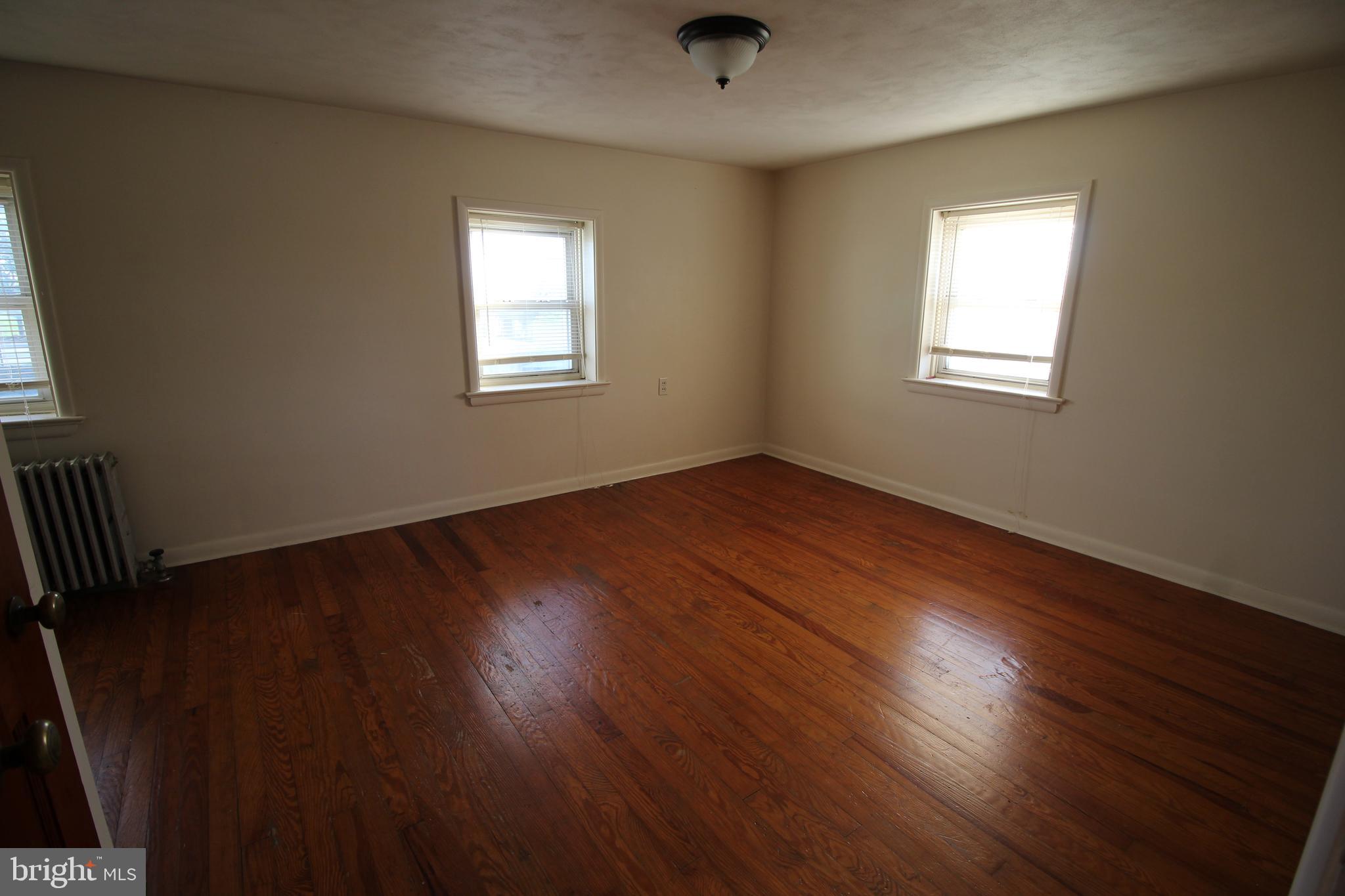 1074 Georgetown Road Paradise, PA 17562 - Photo 6 of 7 an empty room with wooden floor and windows