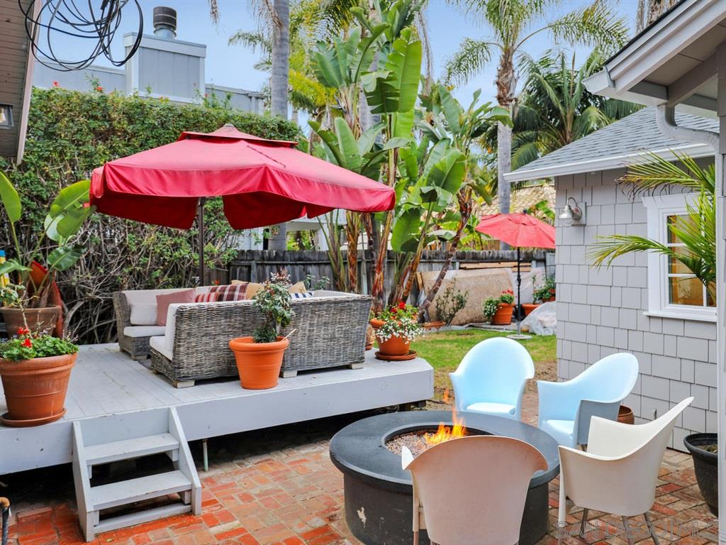 253 26th Street Del Mar, CA 92014 - Photo 15 of 21 a view of a patio with a dining table and chairs under an umbrella
