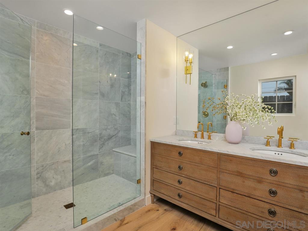 253 26th Street Del Mar, CA 92014 - Photo 17 of 21 a bathroom with a shower sink and mirror