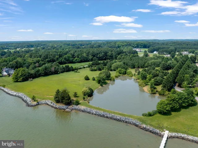 an aerial view of a houses with a yard