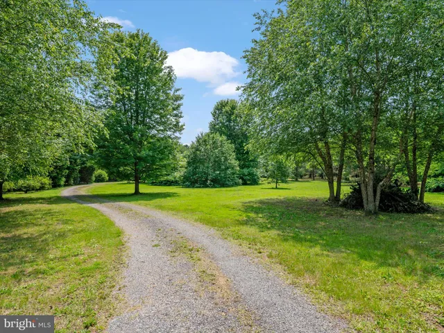 a view of a green field with wooden fence