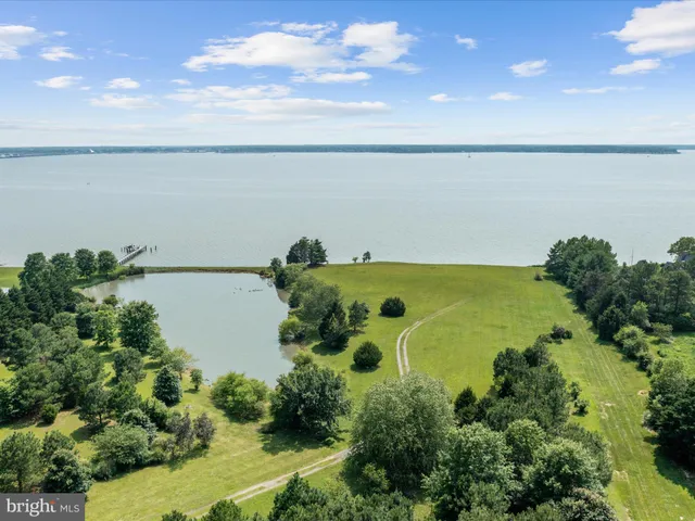 a view of a big yard and a fountain in front of the house