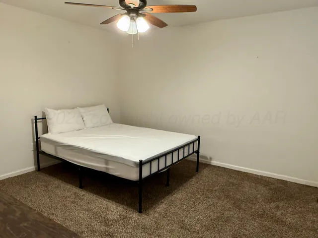 a bed sitting in a room next to a window