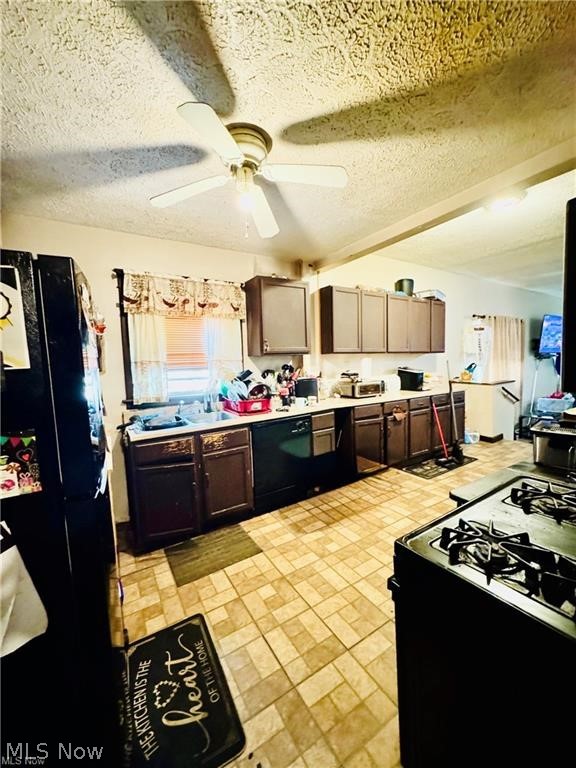 927 Avon Street Akron, OH 44310 - Photo 2 of 12 Kitchen featuring tile flooring, a ceiling fan with integrated lighting, dark wood-finish cabinetry, a double basin sink, and a range with a griddle top