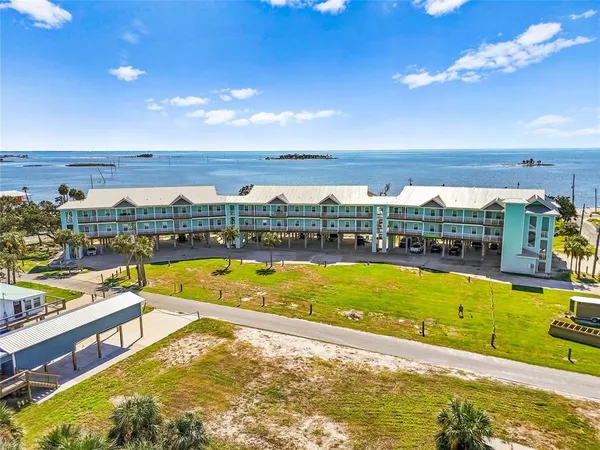 a view of swimming pool with outdoor seating and ocean view
